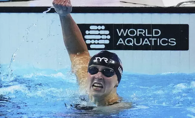 Katie Ledecky of the United States celebrates after winning gold medal in the women's 800-meter freestyle final at the World Aquatics Championships in Singapore, Saturday, Aug. 2, 2025. (AP Photo/Ng Han Guan)