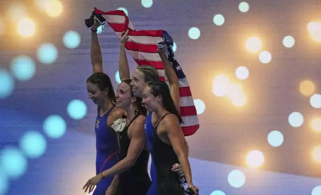 Athletes of team United States celebrate after winning gold medal in the women's 4x100-meter medley relay final at the World Aquatics Championships in Singapore, Sunday, Aug. 3, 2025. (AP Photo/Ng Han Guan)