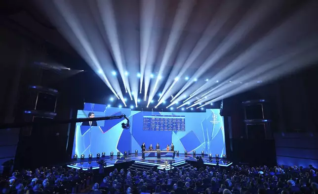 The stage is illuminated during the Champions League soccer league phase draw in Monaco, Thursday, Aug. 28, 2025. (AP Photo/Laurent Cipriani)