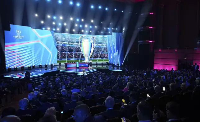 The stage is illuminated before the start of the Champions League soccer league phase draw in Monaco, Thursday, Aug. 28, 2025. (AP Photo/Laurent Cipriani)