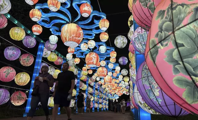 Visitors walk through a lighted tunnel at the Philadelphia Chinese Lantern Festival, Tuesday, Aug. 5, 2025 in Philadelphia. (AP Photo/Tassanee Vejpongsa)