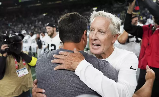 Las Vegas Raiders head coach Pete Carroll hugs Seattle Seahawks head coach Mike Macdonald after an NFL preseason football game Thursday, Aug. 7, 2025, in Seattle. (AP Photo/Lindsey Wasson)