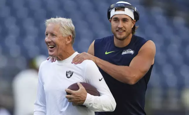 Seattle Seahawks wide receiver Jake Bobo, right, talks with Las Vegas Raiders head coach Pete Carroll before an NFL preseason football game Thursday, Aug. 7, 2025, in Seattle. (AP Photo/Lindsey Wasson)