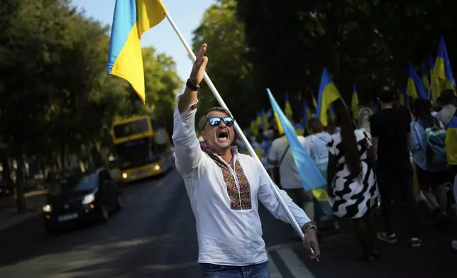 A Ukrainian man shouts slogans during a demonstration to mark Ukraine's Independence Day down Liberdade Avenue in Lisbon, Sunday, Aug. 24, 2025. (AP Photo/Armando Franca)