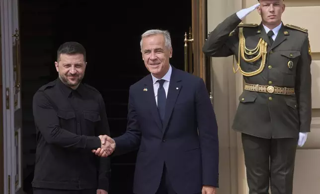 Canadian Prime Minister Mark Carney, right, shakes hands with Ukrainian President Volodymyr Zelenskyy during their meeting in Kyiv, Ukraine, Sunday, Aug. 24, 2025. (AP Photo/Efrem Lukatsky)