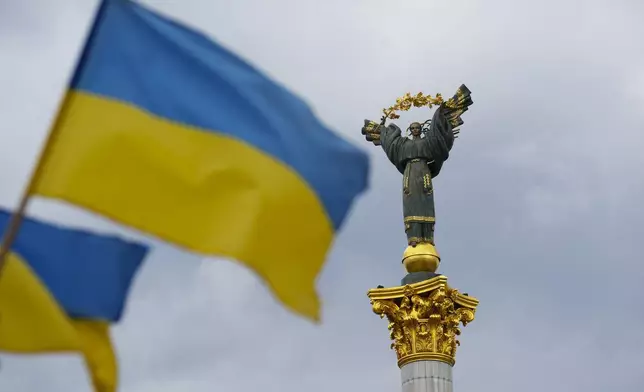 The Independence Monument is pictured as Ukrainian flags blow in the wind in Kyiv, Ukraine, on Saturday, Aug. 23, 2025. (Sean Kilpatrick/The Canadian Press via AP)