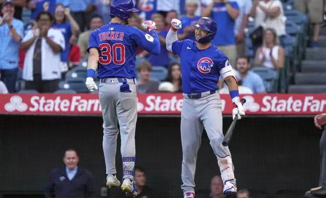 Chicago Cubs' Kyle Tucker is congratulated by Seiya Suzuki after hitting a solo home run during the first inning of a baseball game Friday, Aug. 22, 2025, in Anaheim, Calif. (AP Photo/Mark J. Terrill)