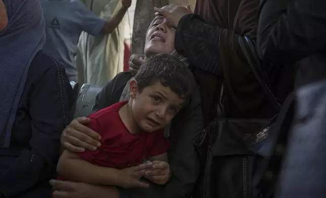 Palestinians mourn during a funeral for family memebers who were killed while trying to reach aid trucks entering northern Gaza Strip, at Shifa Hospital in Gaza City, Aug. 4, 2025. (AP Photo/Jehad Alshrafi)