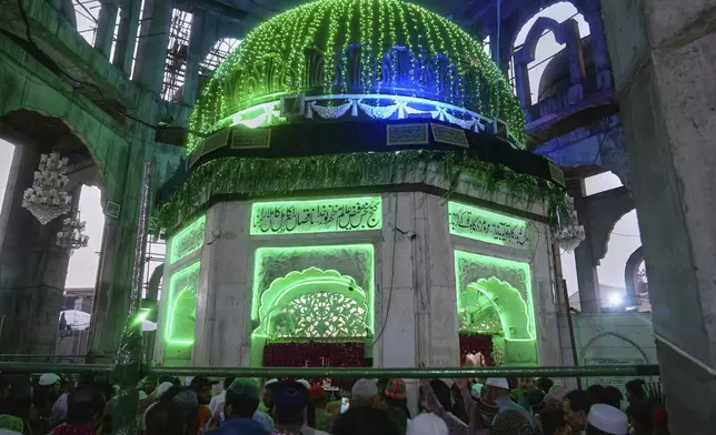 Devotees attend the celebrations of the three-day annual festival or 'Urs' of famous saint Hazrat Ali Hajveri, popularly known as Data Ganj Bakhsh at his shrine, in Lahore, Pakistan, Wednesday, Aug. 13, 2025. (AP Photo/K.M. Chaudary)