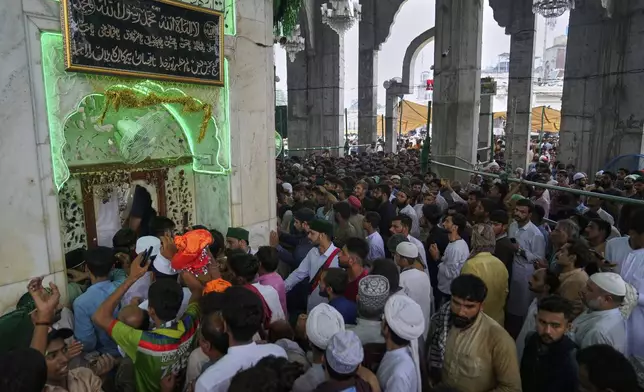 Devotees attending celebrations of the three-day annual festival or 'Urs' of famous saint Hazrat Ali Hajveri, popularly known as Data Ganj Bakhsh at his shrine, in Lahore, Pakistan, Thursday, Aug. 14, 2025. (AP Photo/K.M. Chaudary)