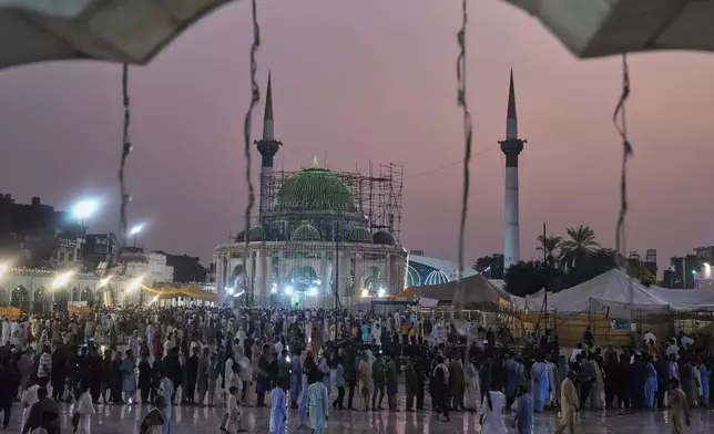 Devotees attend the celebrations of the three-day annual festival or 'Urs' of famous saint Hazrat Ali Hajveri, popularly known as Data Ganj Bakhsh at his shrine, in Lahore, Pakistan, Wednesday, Aug. 13, 2025. (AP Photo/K.M. Chaudary)