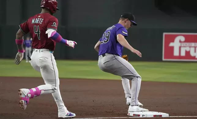 Colorado Rockies pitcher Tanner Gordon gets the out on Arizona Diamondbacks' Ketel Marte (4) in the first inning of a baseball game, Sunday, Aug 10, 2025, in Phoenix. (AP Photo/Rick Scuteri)