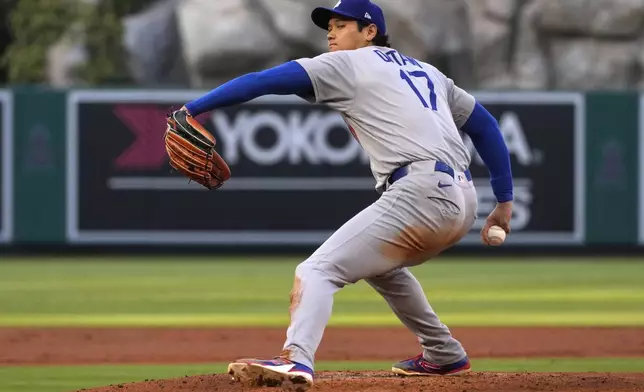 Los Angeles Dodgers starting pitcher Shohei Ohtani throws to the plate during the first inning of a baseball game against the Los Angeles Angels, Wednesday, Aug. 13, 2025, in Anaheim, Calif. (AP Photo/Mark J. Terrill)