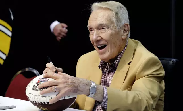 FILE - Hall of Fame coach Marv Levy signs autograph for fans at the inaugural Pro Football Hall of Fame Fan Fest on May 3, 2014, at the International Exposition Center in Cleveland. (AP Photo/Mark Duncan, File)