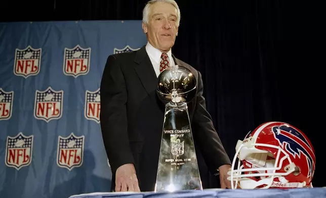 FILE- Buffalo Bills coach Marv Levy poses with the Super Bowl trophy and a Bills helmet on Jan. 28, 1994 in Atlanta following a news conference. (AP Photo/Susan Walsh, File)