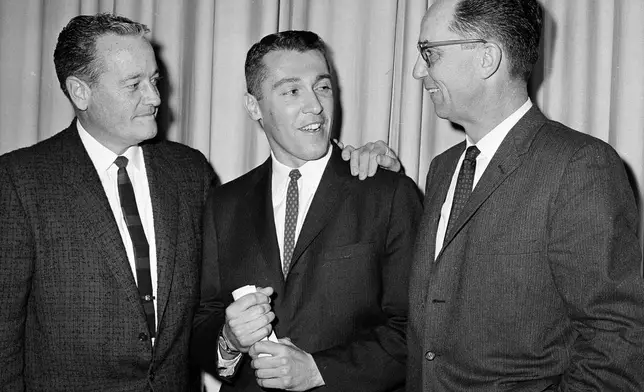 FILE - Marv Levy, center, stands with Paul Hastings, left, and Greg Engelhard after it was announced that Levy would be the new head coach of the University of California, in Berkeley, Calif., Feb. 5, 1960. (AP Photo/Clarence Hamm, File)