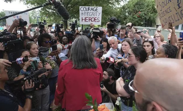 Dr. Debra Houry talks to workers and supporters as they rally for departing scientific leaders at the Centers for Disease Control and Prevention outside the CDC headquarters, Thursday, Aug. 28, 2025, in Atlanta. (AP Photo/Ben Gray)