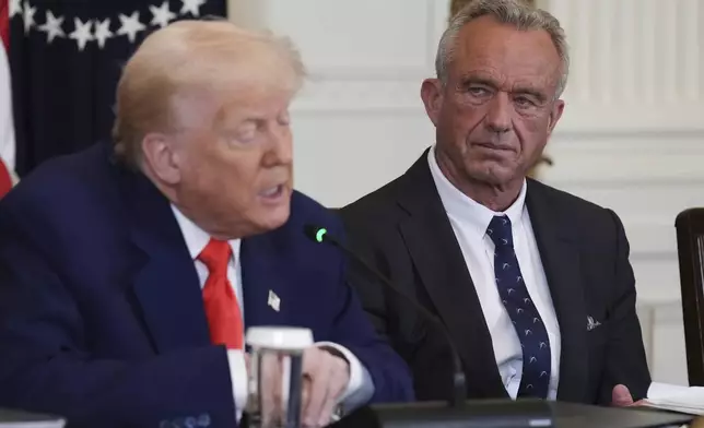 FILE - President Donald Trump, left, speaks as Health and Human Services Secretary Robert F. Kennedy Jr. listens during a Make America Healthy Again (MAHA) Commission Event in the East Room of the White House, Thursday, May 22, 2025, in Washington. (AP Photo/Jacquelyn Martin, File)