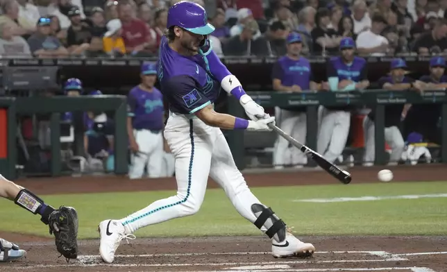 Arizona Diamondbacks' Blaze Alexander hits a three-run double against the Colorado Rockies in the first inning of a baseball game Friday, Aug. 8, 2025, in Phoenix. (AP Photo/Rick Scuteri)