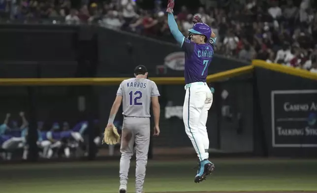 Arizona Diamondbacks' Corbin Carroll (7) reacts after hitting a two-run home run against the Colorado Rockies in the fifth inning of a baseball game, Friday, Aug. 8, 2025, in Phoenix. (AP Photo/Rick Scuteri)
