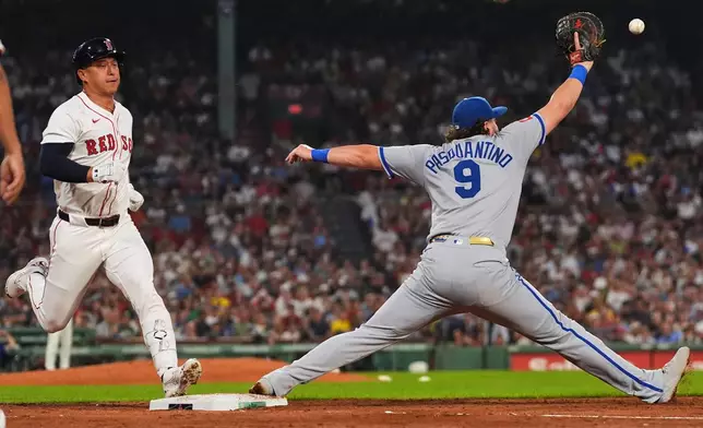 Kansas City Royals first baseman Vinnie Pasquantino (9) stretches for a throw on a groundout by Boston Red Sox designated hitter Rob Refsnyder, left, during the third inning of a baseball game at Fenway Park, Monday, Aug. 4, 2025, in Boston. (AP Photo/Charles Krupa)