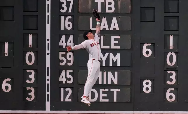 Boston Red Sox outfielder Jarren Duran leaps to catch a line-out by Kansas City Royals' Kyle Isbel during the fourth inning of a baseball game at Fenway Park, Monday, Aug. 4, 2025, in Boston. (AP Photo/Charles Krupa)