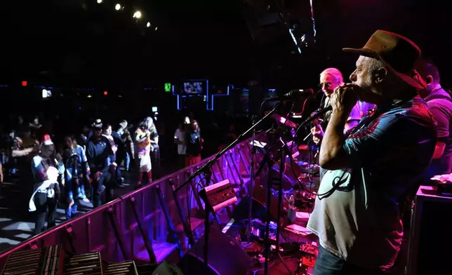 Harmonica player Don DeStefano, right, plays with the band Creamery Station at Toad's Place in New Haven, Conn., on Friday, May 9, 2025. (AP Photo/Jessica Hill)