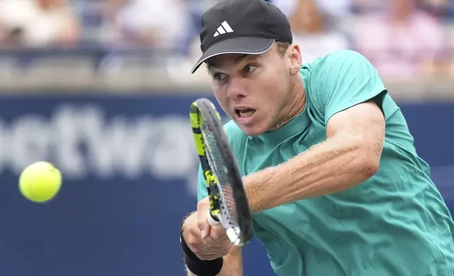 Alex Michelsen, of the United States, returns the ball against Lorenzo Musetti, of Italy, during a match at the National Bank Open men’s tennis tournament, Thursday, July 31, 2025, in Toronto. (Nathan Denette/The Canadian Press via AP)