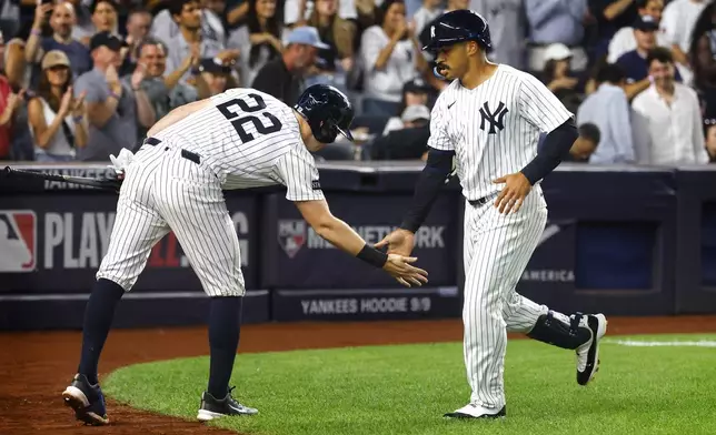 New York Yankees' Ben Rice (22) congratulates Trent Grisham, right, after Grisham hit a home run during the third inning of a baseball game against the Boston Red Sox, Sunday, Aug. 24, 2025, in New York. (AP Photo/Noah K. Murray)
