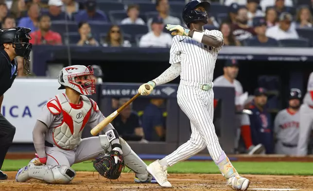 New York Yankees' Jazz Chisholm Jr. follows through on a two run home run during the second inning of a baseball game against the Boston Red Sox, Sunday, Aug. 24, 2025, in New York. (AP Photo/Noah K. Murray)