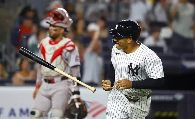 New York Yankees' Trent Grisham tosses his bat after hitting a home run during the fifth inning of a baseball game against the Boston Red Sox, Sunday, Aug. 24, 2025, in New York. (AP Photo/Noah K. Murray)