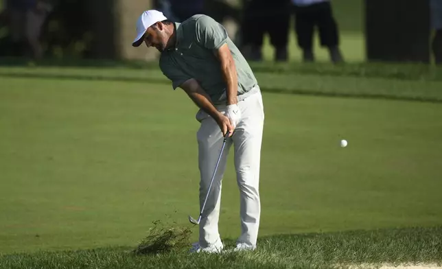 Scottie Scheffler hits from the rough on the 16th hole during the second round of the BMW Championship golf tournament at Caves Valley Golf Club, Friday, Aug. 15, 2025, in Owings Mills, Md. (AP Photo/Nick Wass)