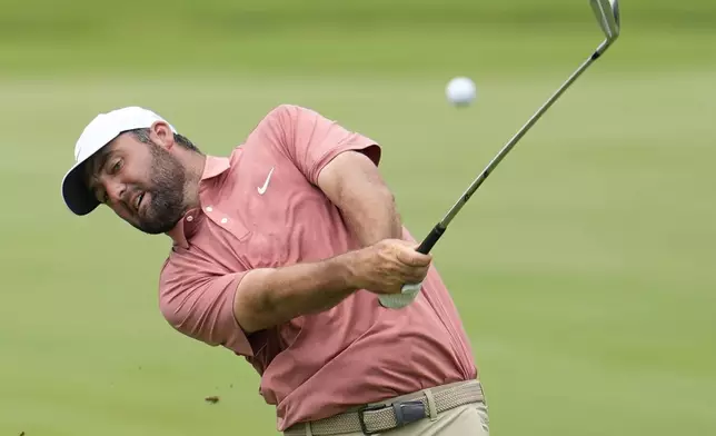 Scottie Scheffler hits from the first fairway during the first round of the Tour Championship golf tournament, Thursday, Aug. 21, 2025, in Atlanta. (AP Photo/Mike Stewart)