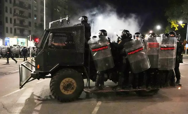 Serbian gendarmerie officers patrol in truck after clearing people blocking a street during an anti-government protest in Belgrade, Serbia, Saturday, Aug. 16, 2025. (AP Photo/Darko Vojinovic)