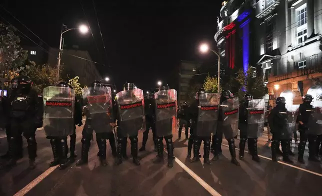 Serbian gendarmerie officers guard a street during an anti-government protest near the Serbian Progressive Party office in Belgrade, Serbia, Friday, Aug. 15, 2025. (AP Photo/Darko Vojinovic)
