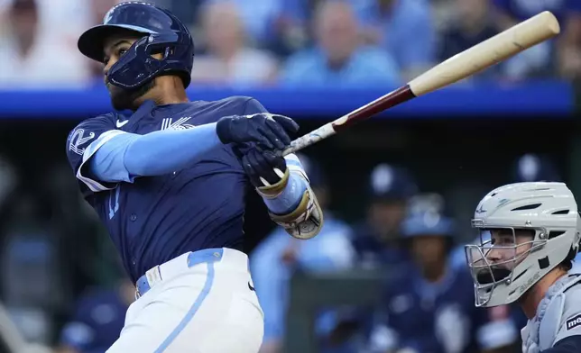 Kansas City Royals' Maikel Garcia watches his two-run home run during the first inning of a baseball game against the Detroit Tigers, Friday, Aug. 29, 2025, in Kansas City, Mo. (AP Photo/Charlie Riedel)