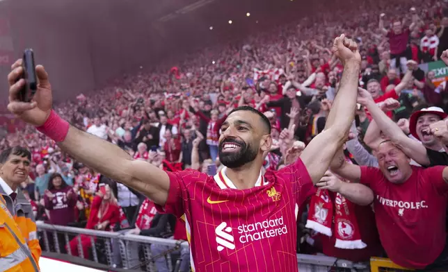 FILE - Liverpool's Mohamed Salah celebrates by taking a selfie after winning the English Premier League soccer match between Liverpool and Tottenham Hotspur and clinching the Premier League title at Anfield in Liverpool, England, Sunday, April 27, 2025. (AP Photo/Jon Super, File)