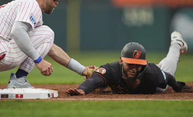 Philadelphia Phillies first base Bryce Harper tags out Baltimore Orioles' Jeremiah Jackson during the second inning of a baseball game, Tuesday, Aug. 5, 2025, in Philadelphia. (AP Photo/Matt Rourke)