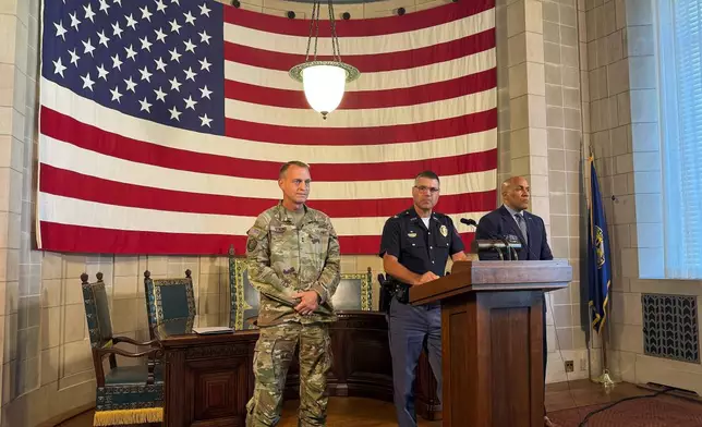Nebraska State Patrol Superintendent Colonel Bryan Waugh, center, flanked by National Guard Adjutant General Maj. Gen. Craig W. Strong, left, and Department of Correctional Services Director Rob Jeffreys, speaks about plans for a new immigration detention center and an agreement to allow state troopers to enforce immigration laws at a news conference at the Nebraska State Capitol in Lincoln, Neb., Tuesday, Aug. 19, 2025. (AP Photo/Josh Funk)