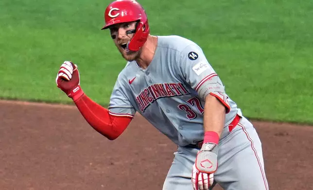 Cincinnati Reds' Tyler Stephenson celebrates as he stands on second base after hitting a double off Pittsburgh Pirates pitcher Dauri Moreta, driving in a run, during the sixth inning of a baseball game in Pittsburgh, Friday, Aug. 8, 2025. (AP Photo/Gene J. Puskar)