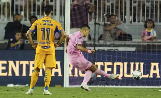 Inter Miami forward Luis Suárez kicks a penalty for a goal during the first half of a Leagues Cup quarterfinal soccer match against Tigres UANL, Wednesday, Aug. 20, 2025, in Fort Lauderdale, Fla. (AP Photo/Lynne Sladky)