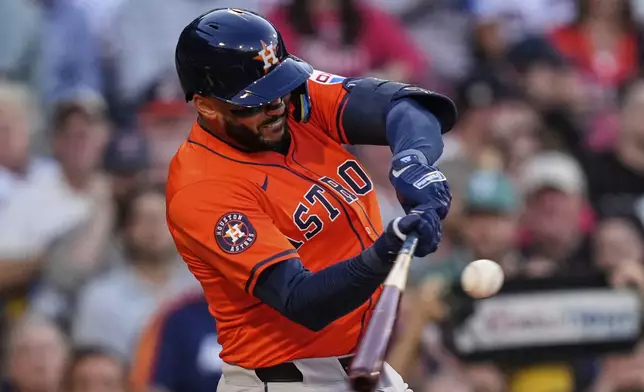 Houston Astros designated hitter Carlos Correa connects on a flyout in the second inning of a baseball game against the Boston Red Sox at Fenway Park, Friday, Aug. 1, 2025, in Boston. (AP Photo/Charles Krupa)