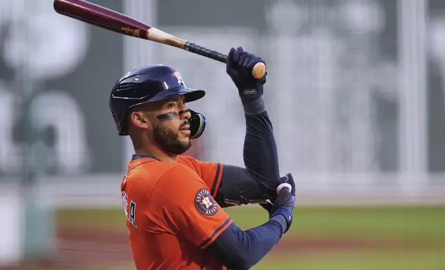 Houston Astros designated hitter Carlos Correa prepares to hit during the first inning of a baseball game against the Boston Red Sox at Fenway Park, Friday, Aug. 1, 2025, in Boston. (AP Photo/Charles Krupa)