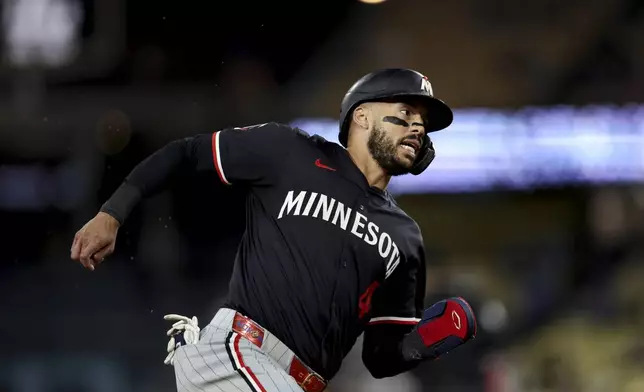 Minnesota Twins' Carlos Correa runs towards home plate during the ninth inning of a baseball game against the Los Angeles Dodgers Tuesday, July 22, 2025, in Los Angeles. (AP Photo/Eric Thayer)
