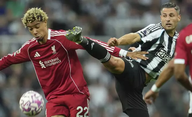Liverpool's Hugo Ekitike, left, and Newcastle's Fabian Schaer fight for the ball during the Premier League soccer match between Newcastle and Liverpool in Newcastle, England, Monday, Aug. 25, 2025. (AP Photo/Jon Super)
