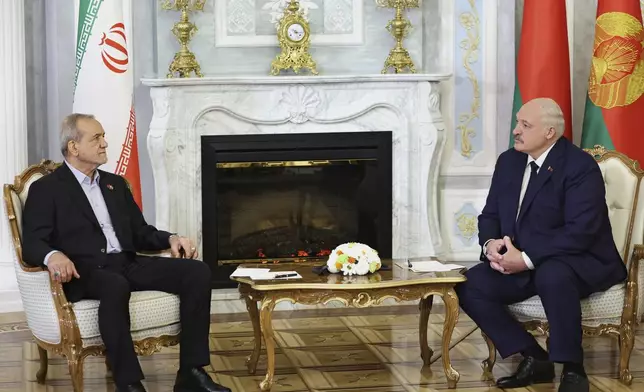 In this photo, released by Belarusian Presidential Press Service, Belarusian President Alexander Lukashenko, right, and Iranian President Masoud Pezeshkian talk to each other during their meeting in Minsk, Belarus, Wednesday, Aug. 20, 2025. (Belarusian Presidential Press Service via AP)