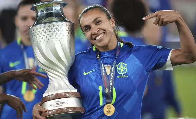 Brazil's Marta holds the trophy after winning the Women's Copa America final soccer match against Colombia in a penalty shootout at Rodrigo Paz Delgado stadium in Quito, Ecuador, Saturday, (AP Photo/Dolores Ochoa)