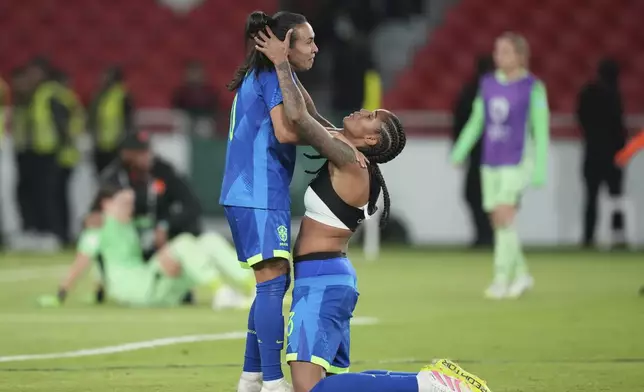 Brazil's Marta, left, and Tarciane celebrate after winning the Women's Copa America final soccer match against Colombia in a penalty shootout at Rodrigo Paz Delgado stadium in Quito, Ecuador, Saturday, Aug. 2, 2025. (AP Photo/Dolores Ochoa)