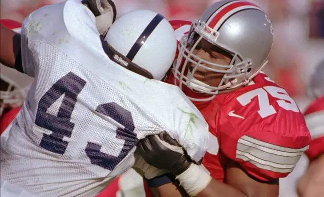 FILE - Ohio State tackle Orlando Pace (75) pushes Penn State linebacker Brandon Short (43) aside as the Buckeyes beat the Nittany Lions 38-7 in an NCAA college football game, Saturday, Oct. 5, 1996, in Columbus, Ohio. (AP Photo/Mark Hall, File)