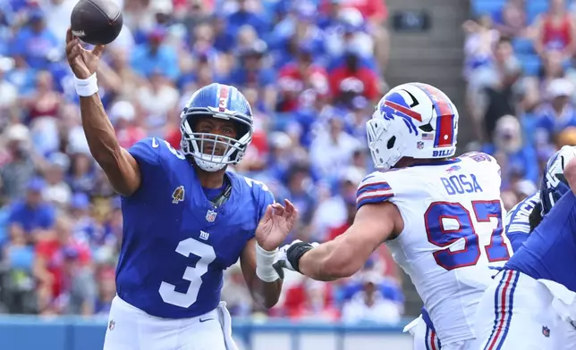 New York Giants quarterback Russell Wilson (3) throws a pass over Buffalo Bills' Joey Bosa (97) during the first half of an NFL preseason football game Saturday, Aug. 9, 2025, in Orchard Park, N.Y. (AP Photo/Jeffrey T. Barnes)